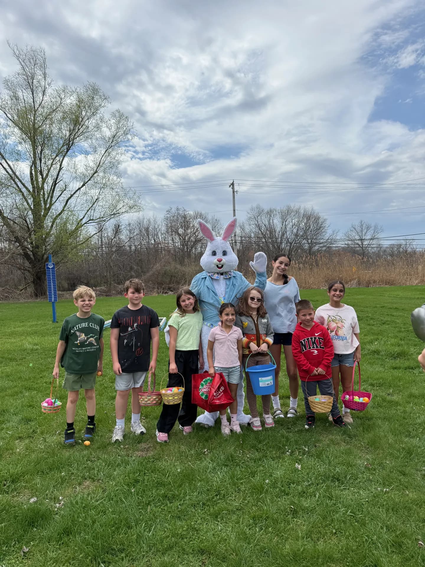Kids with Easter baskets posing with the Easter Bunny