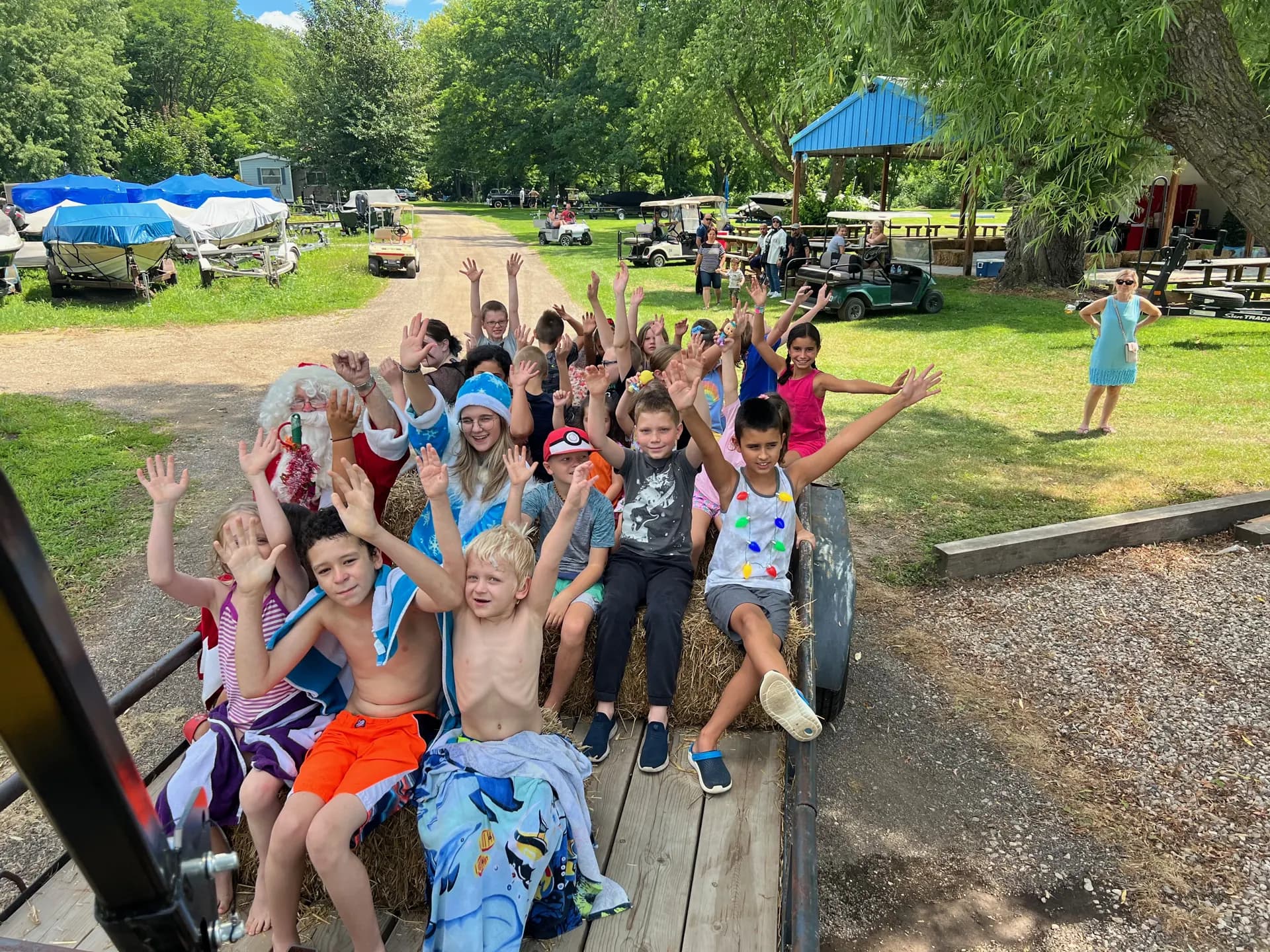 Kids waving from a hay wagon ride through the campground