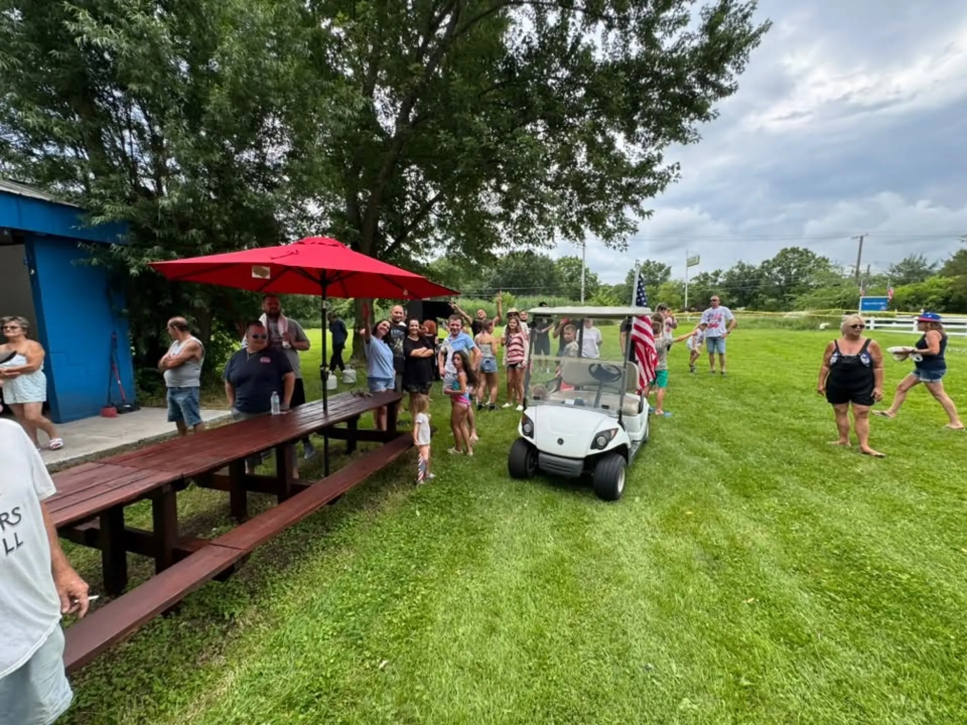 Campers gathering at the picnic tables near the lodge